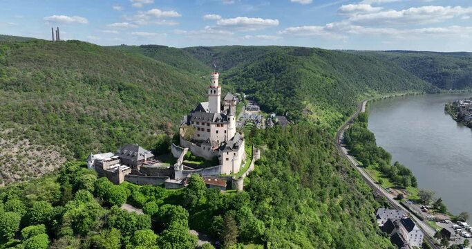 Marksburg Castle on hill. Rhine River in background. Braubach in Rhineland Palatinate, Germany. Aerial view.
