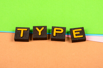 TYPE. Old letter tiles on a colored paper background