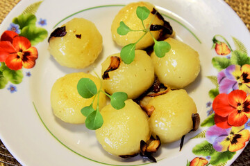 National dish of Belarus. Fried potato dumplings with onion, decorated with salad