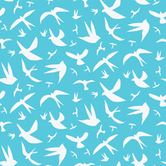White silhouette flock of flying birds seamless pattern on blue background. For textile, fabric and home decor.