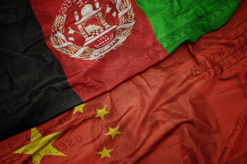 waving colorful flag of afghanistan and national flag of china on the dollar money background....