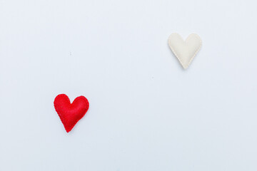 Red felt valentine heart hanging from a rope fixed by wooden clothespin isolated on white background