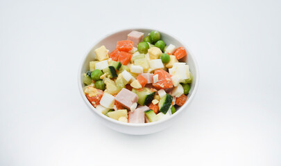 Vegetable salad with meat and sauce in a white salad bowl. A small snack.