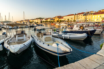 Obraz premium Boats at sunset in the marina of Mali on the island of Losinj in the Adriatic Sea, Croatia