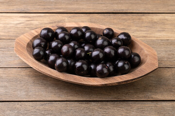 Jabuticabas on a bowl over wooden table