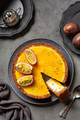 Top view of Vanilla Cheesecake with mango and passion fruit topping. Homemade fruit baked dessert...