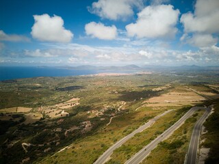 panorama of north sardinia. Picture of winding mountainroad, sea and city.
