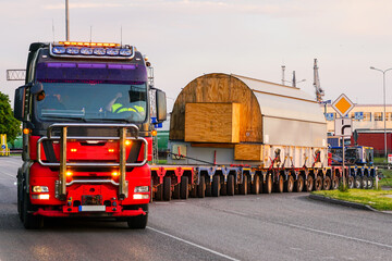 Truck with a very long specialized multi-axle trailer carries a very heavy oversize cargo