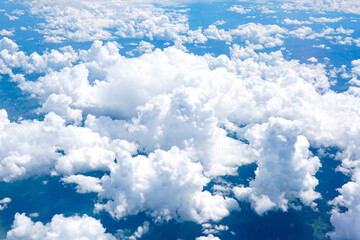 Landscape of beautiful fluffy puffy white cumulus clouds on blue sky background, top view