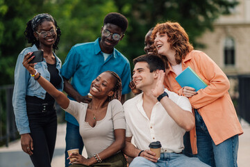 Interracial college friends taking selfies at university campus.