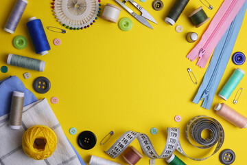 A wide range of sewing materials and tools is located on a colored background