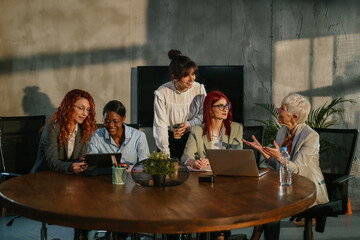 Group of interracial businesswomen brainstorming and collaborating.