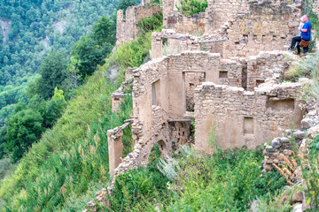 Dagestan Gamsutl. Ancient ghost town of Gamsutl old stone houses in abandoned Gamsutl mountain village in Dagestan, Abandoned etnic aul, summer landscape.