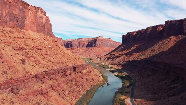 Travel by car through national parks of USA with picturesque landscapes of nature. Flying over Colorado River in rocky gorge of red canyon similar to Grand Canyon. Moving forward to an unknown goal
