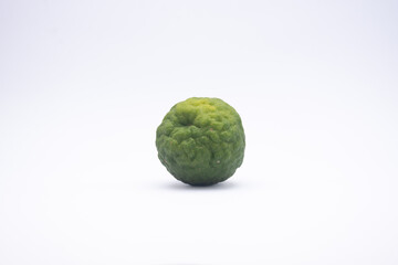 The kaffir lime is not yet ripe and green isolated on white