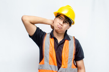 Title	
young asian man construction worker using yellow helmet and orange vest makes a thinking gesture. asian male worker in pensive expression while thinking looking for idea.