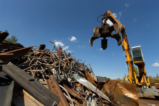 Excavator for loading scrap metal.