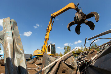 Excavator for loading scrap metal.