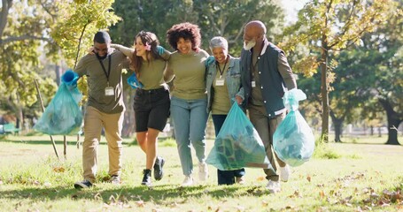Happy, plastic bag or people in park walking for waste management or recycling in community service. Group, teamwork or proud volunteers cleaning garbage, junk or rubbish for nature sustainability