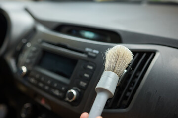 Car Interior Cleaning process underway with a brush for detailed professional detailing