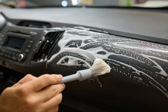 Car Interior Cleaning process underway with a brush for detailed professional detailing