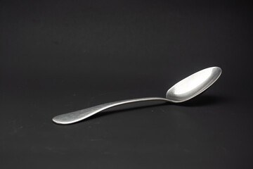 tablespoon made of stainless steel on black background