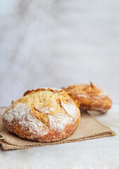 Freshly baked round bread . Close up