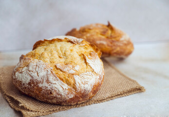 Freshly baked round bread . Close up