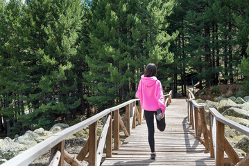 Woman Stretching her  legs in the mountain 