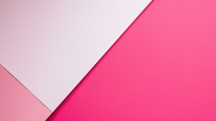 Fototapeta premium A top-down view of a pink and white paper background with a distinct diagonal division line