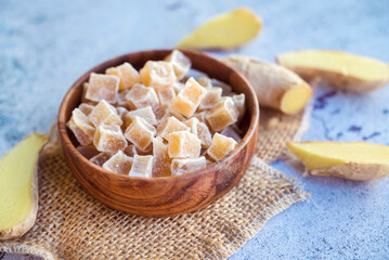 Ginger with sugar in wooden bowl