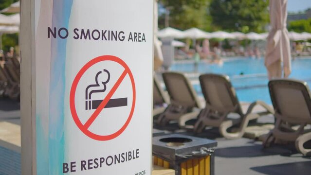 Sign indicating a no smoking area by the pool in 4k slow motion 60fps