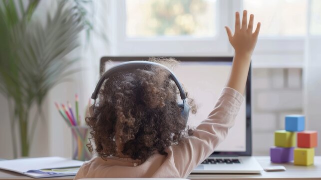 Child learning at home with video call, laptop, and mockup for pandemic, education, and knowledge. With girl student in quarantine, school, and online courses, raised hand for virtual classroom study