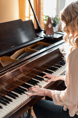 Blonde woman playing antique piano