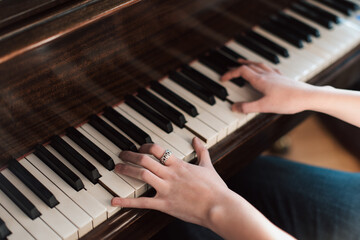 Fototapeta premium Caucasian hands playing piano key