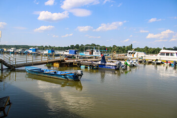 Boat dock on the green Danube on a sunny day in June - location Stari Slankamen, Vojvodina Province, Serbia