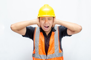 stressed overworked concept illustrated by asian male construction worker in orange vest and yellow safety helmet with furious, mad, sad, angry expression. 