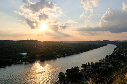 Sunset view over the river with boats going by.