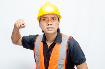 Asian male construction worker in a safety helmet and orang vest doing protest, rejecting and...