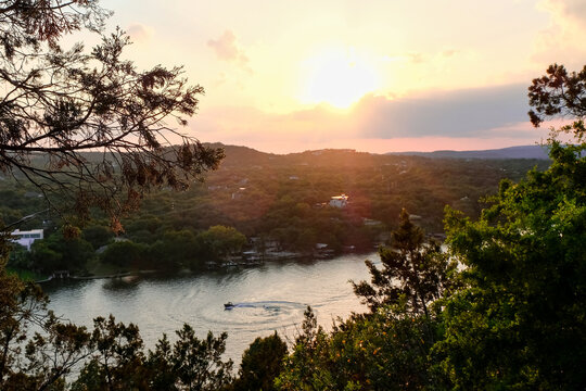 Sunset over the river with a boat having summer fun