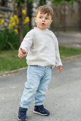 Fototapeta premium Curious toddler pointing and exploring outdoors