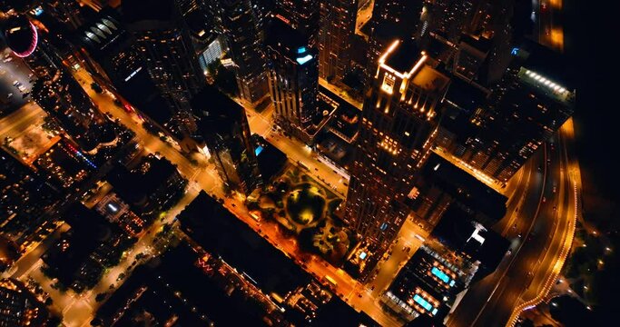 Brightly illuminated streets of Chicago, Illinois, USA. Night view of the city from bird's eye perspective.