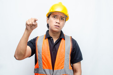 stressed overworked concept illustrated by asian male construction worker in orange vest and yellow safety helmet with furious, mad, sad, angry expression. 