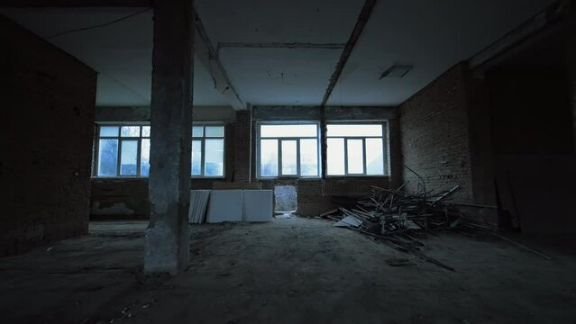 White square pieces of construction materials placed under the window of an unfinished premise. Some debris are left in a pile in the corner. Construction or reconstruction concept.