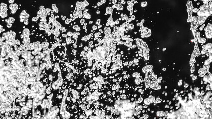 Flying water drops on black background