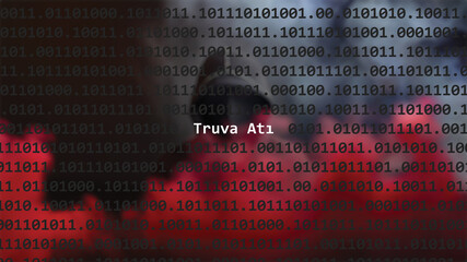 Cyber attack. Translation: trojan horse text in foreground screen, anonymous hacker hidden with hoodie in the blurred background. Vulnerability text in binary system code on editor program.