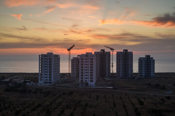 The glow of the sunset sky, the crane of a large rental building 1