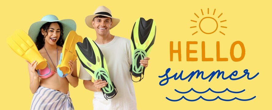 Happy young couple with flippers on yellow background. Hello, summer