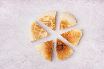 Pieces of tasty pita bread on white background