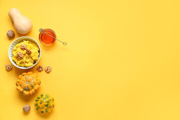 Bowl of tasty millet porridge with pumpkin and ingredients on orange background